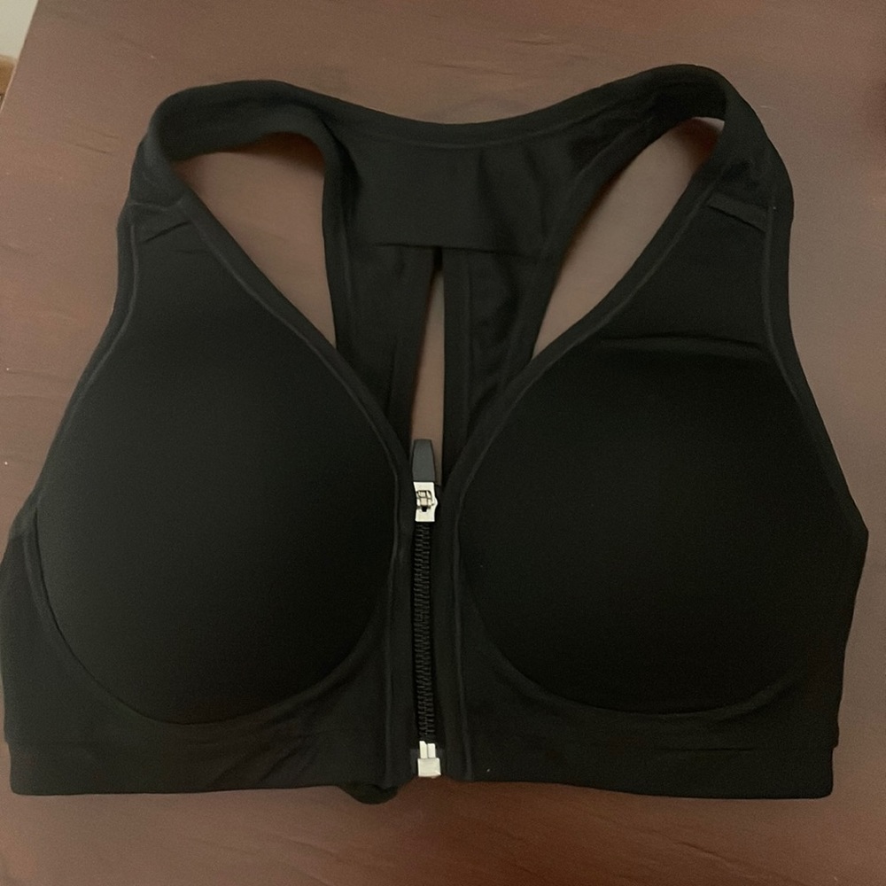 Black sports bra with zipper. Never worn.